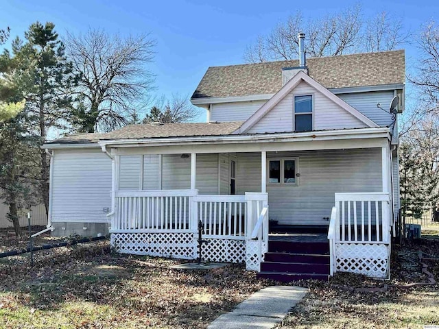 view of front of property with a porch and central AC unit