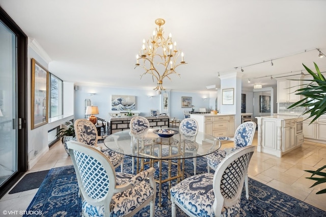 dining space featuring an inviting chandelier, light tile patterned floors, and ornamental molding