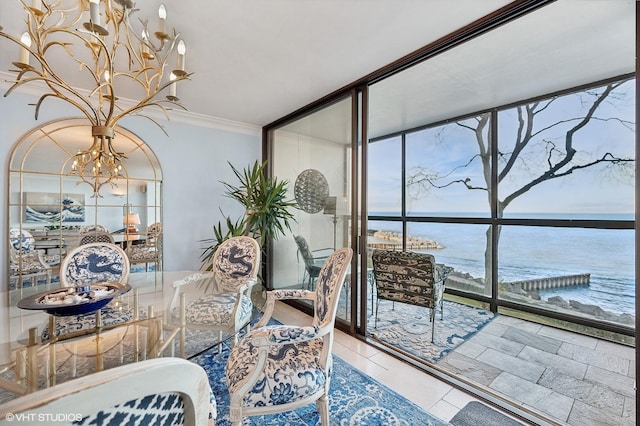 interior space with a water view, a wall of windows, ornamental molding, and a chandelier