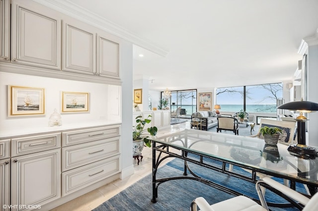 tiled office space featuring crown molding, a water view, and a wall of windows