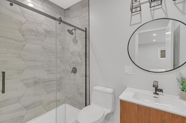 bathroom with vanity, an enclosed shower, and toilet