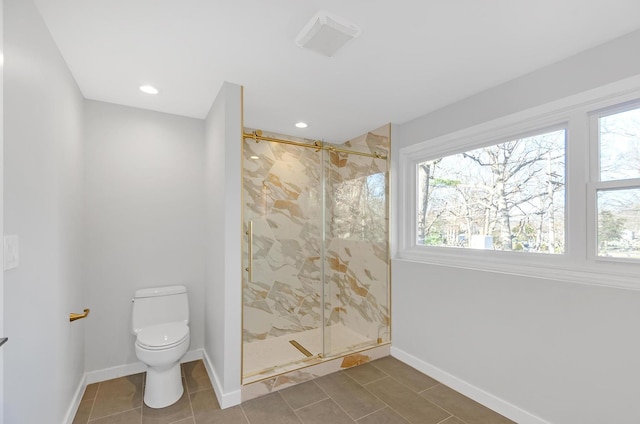 bathroom featuring tile patterned flooring, toilet, and a shower with shower door