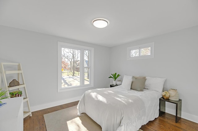 bedroom with dark hardwood / wood-style flooring