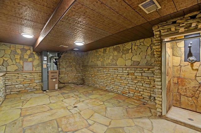 basement featuring heating unit and wood ceiling