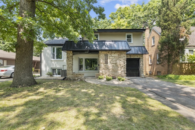 view of front of home with a front lawn and a garage