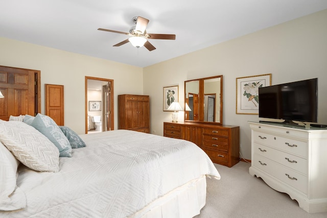 carpeted bedroom with ceiling fan and ensuite bath