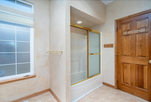 bathroom with shower / bath combination with glass door