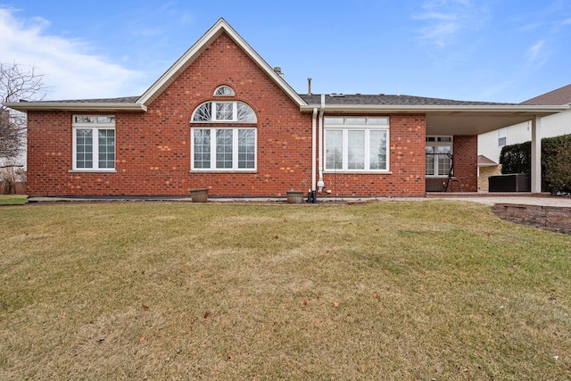 rear view of property with a yard