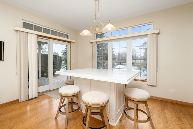 dining room featuring a notable chandelier and light wood-type flooring