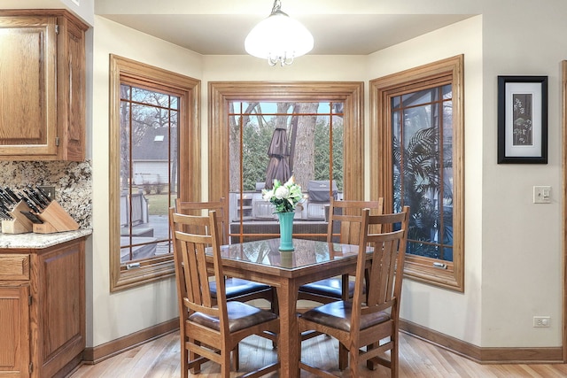 dining room with baseboards and light wood finished floors