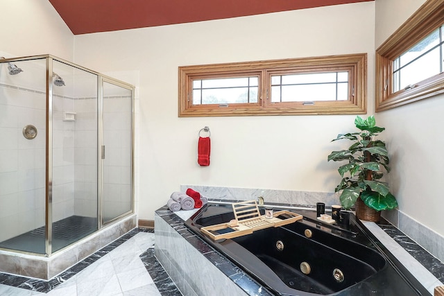 bathroom featuring a stall shower and a whirlpool tub