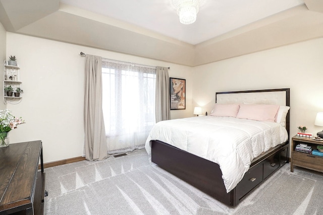 bedroom featuring light colored carpet and baseboards