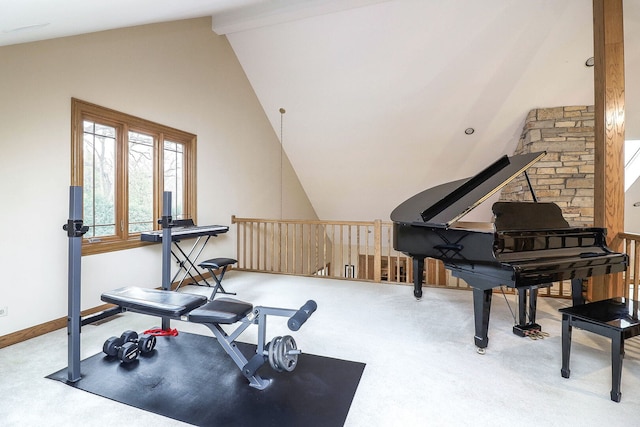 exercise area featuring high vaulted ceiling, baseboards, and carpet