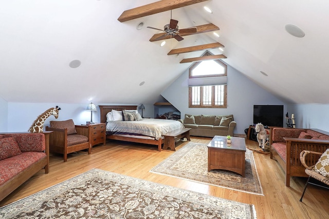 bedroom with lofted ceiling with beams and light wood-style floors