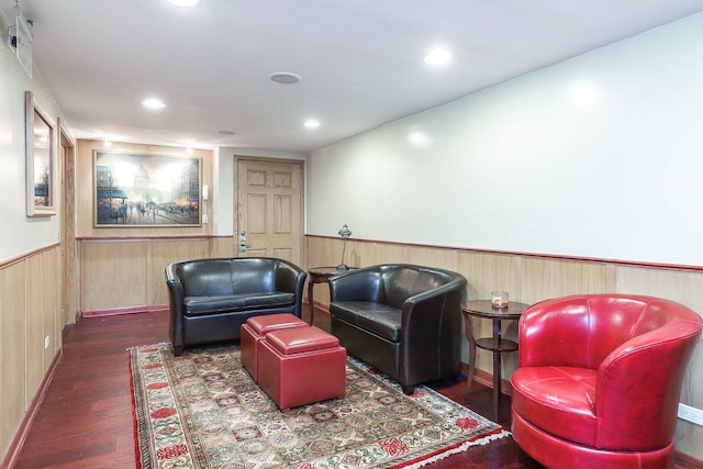 sitting room with recessed lighting, wooden walls, wood finished floors, and wainscoting