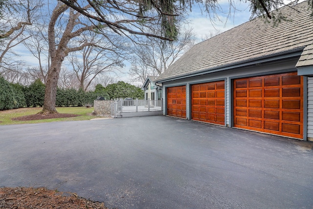 garage featuring a gate and driveway