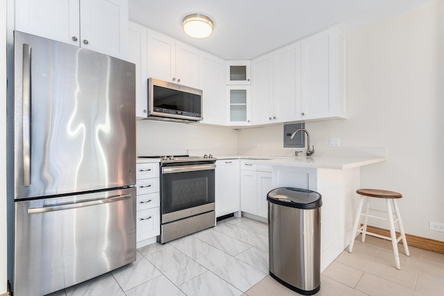 kitchen featuring white cabinets, stainless steel appliances, and sink