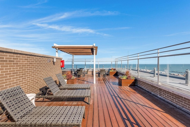 wooden terrace with a beach view and a water view