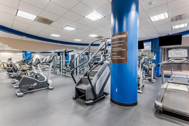 exercise room with a paneled ceiling