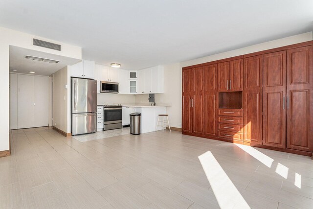 unfurnished living room with light tile patterned flooring