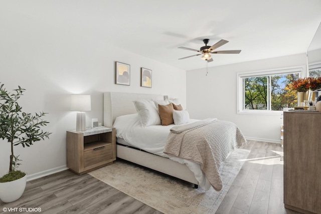 bedroom with hardwood / wood-style floors and ceiling fan