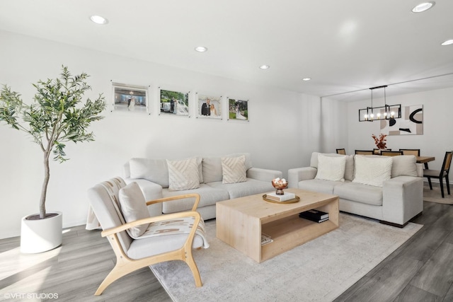 living room featuring hardwood / wood-style flooring and an inviting chandelier