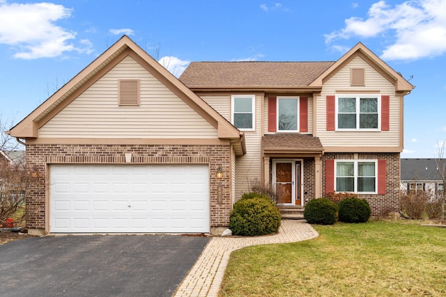 view of front property featuring a front lawn and a garage