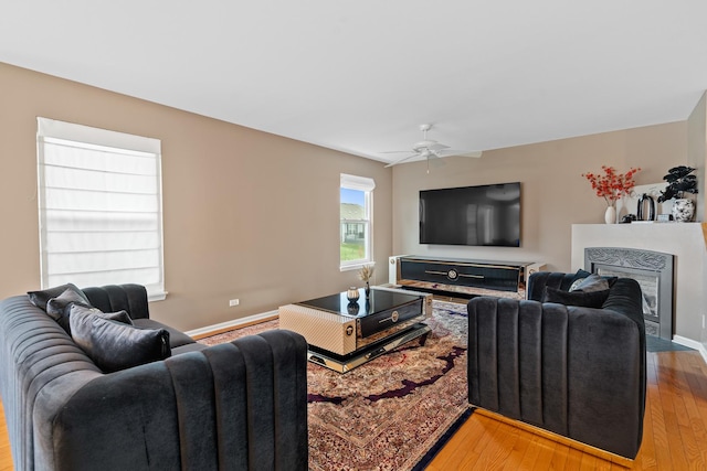 living room featuring ceiling fan and light wood-type flooring