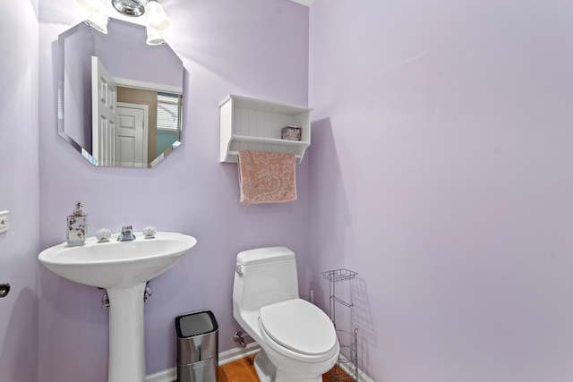 bathroom with wood-type flooring and toilet