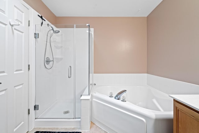 bathroom with shower with separate bathtub, vanity, and tile patterned floors