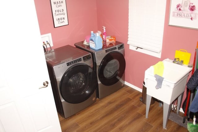 laundry room featuring dark wood-type flooring and washing machine and clothes dryer