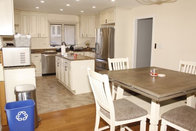 kitchen featuring a center island, stainless steel appliances, and light hardwood / wood-style flooring