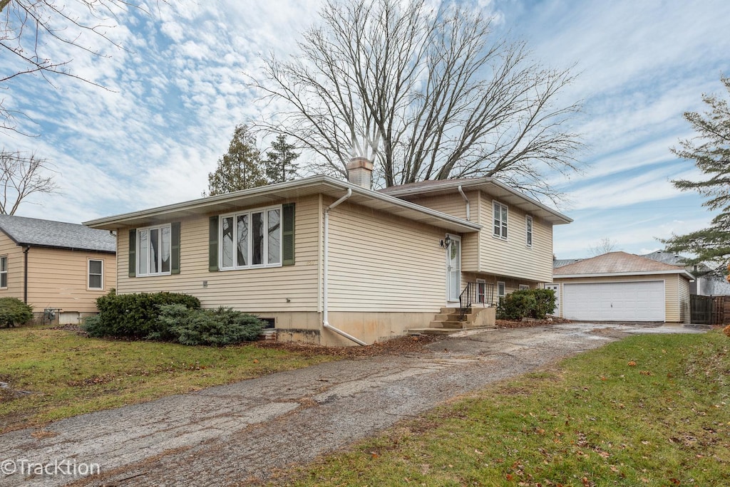 view of front of home with an outbuilding, a garage, and a front yard