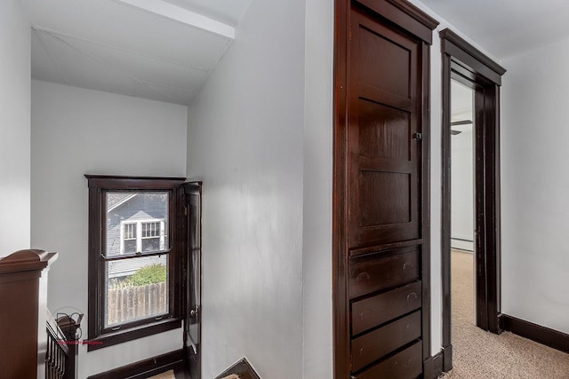 hall featuring light carpet and lofted ceiling