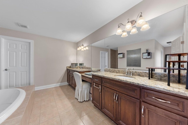 bathroom with vanity, tiled bath, and tile patterned floors