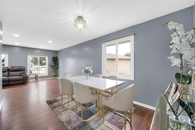 dining room featuring dark wood-type flooring and an inviting chandelier