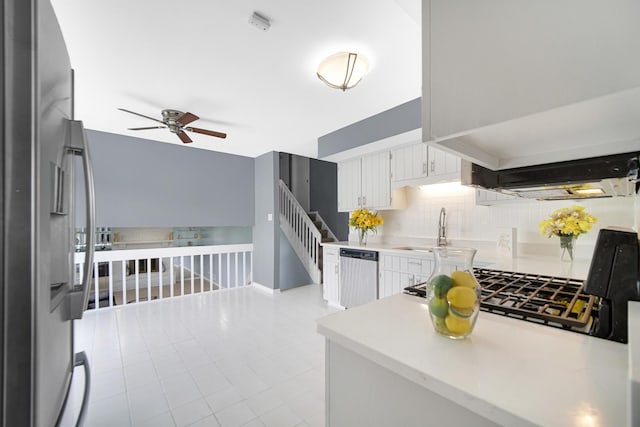 kitchen featuring backsplash, stainless steel appliances, sink, light tile patterned floors, and white cabinets