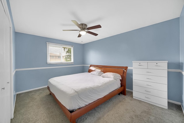 bedroom featuring ceiling fan, a closet, and light carpet