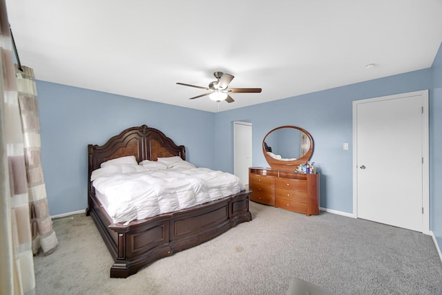 bedroom with ceiling fan and light colored carpet