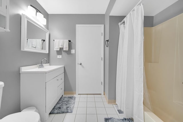 full bathroom featuring tile patterned flooring, vanity, toilet, and shower / bath combo with shower curtain