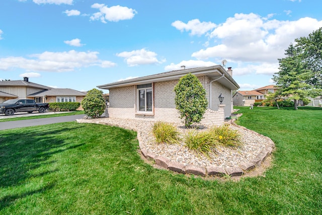 view of property exterior with a lawn