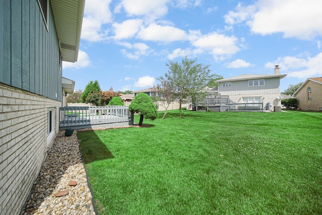 view of yard featuring a wooden deck