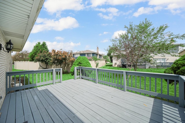 wooden deck featuring a yard