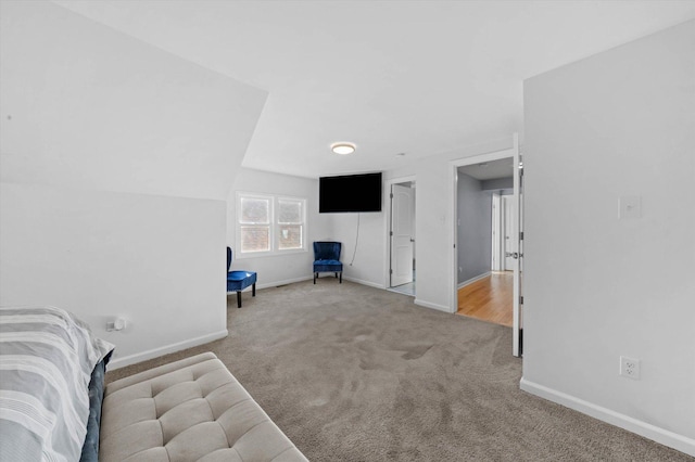 interior space with carpet and vaulted ceiling