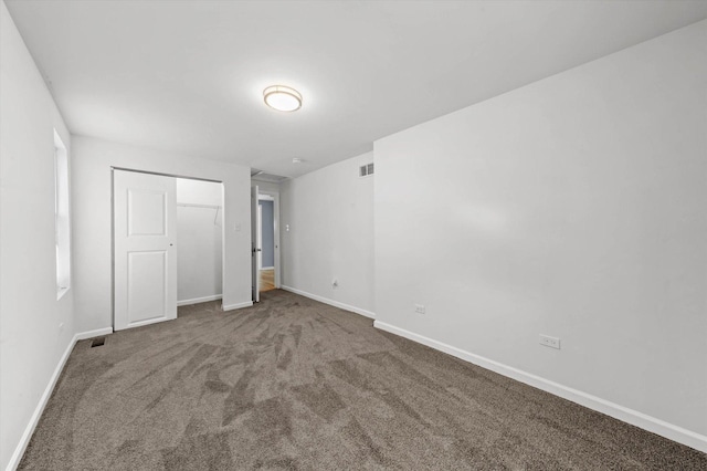 unfurnished bedroom featuring carpet floors and a closet