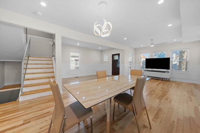 dining space with light hardwood / wood-style floors and ceiling fan