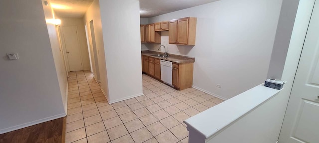 kitchen with dishwasher, light tile patterned floors, and sink