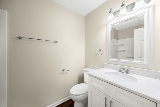 bathroom featuring a shower, vanity, wood-type flooring, and toilet