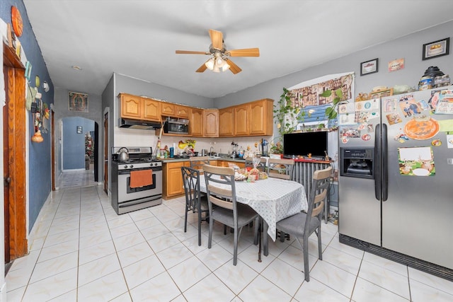 kitchen with backsplash, ceiling fan, light tile patterned flooring, and appliances with stainless steel finishes