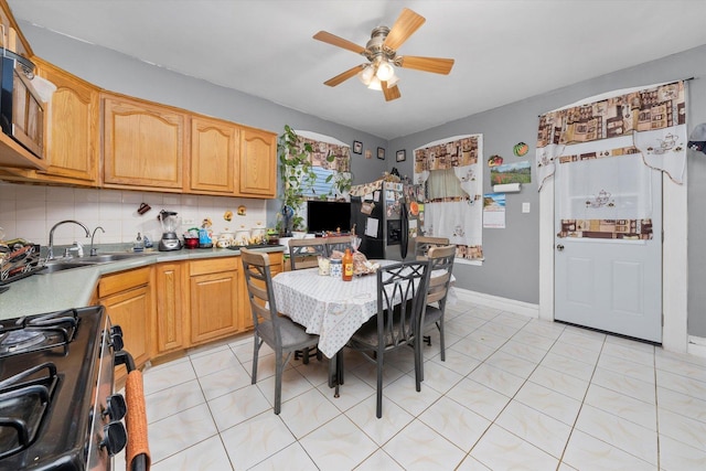 kitchen with ceiling fan, sink, backsplash, light tile patterned flooring, and black appliances